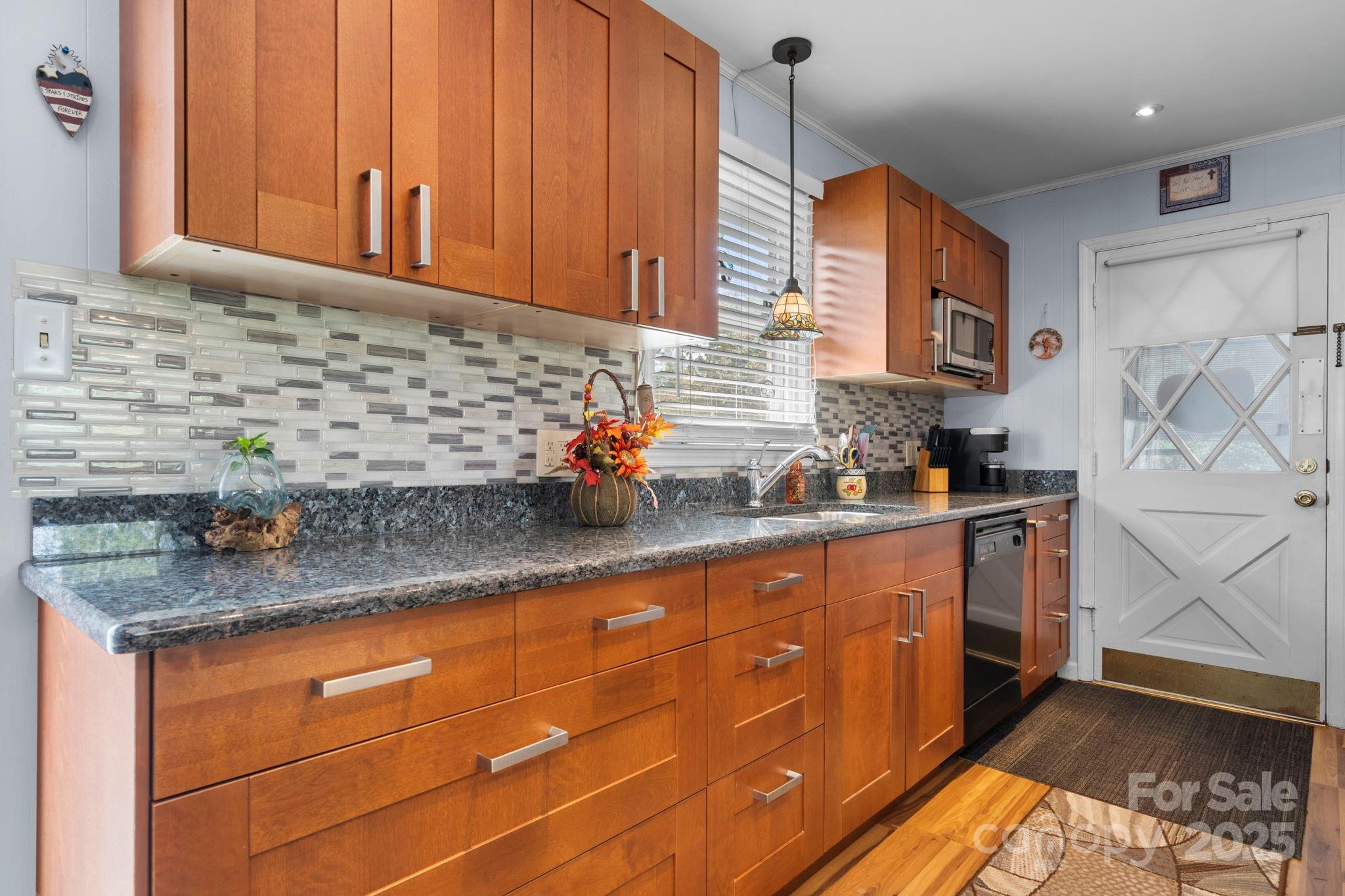 3651 Pea Ridge Road Morganton, NC 28655 - Photo 16 of 43 a kitchen with stainless steel appliances granite countertop a sink stove and cabinets