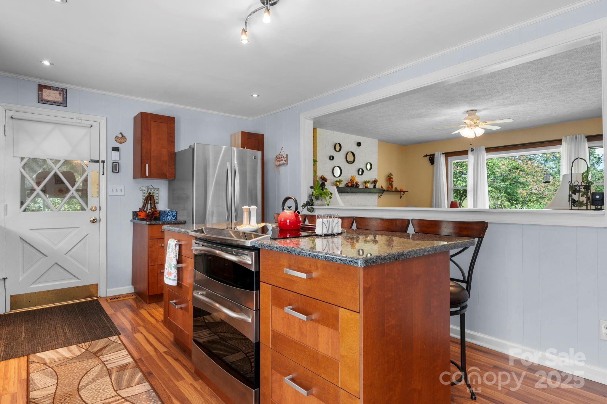 3651 Pea Ridge Road Morganton, NC 28655 - Photo 17 of 43 a kitchen with stainless steel appliances granite countertop a stove and a refrigerator