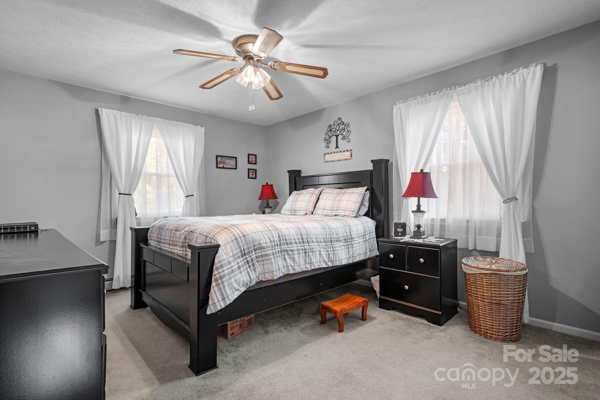 3651 Pea Ridge Road Morganton, NC 28655 - Photo 20 of 43 a bedroom with a bed and a chandelier