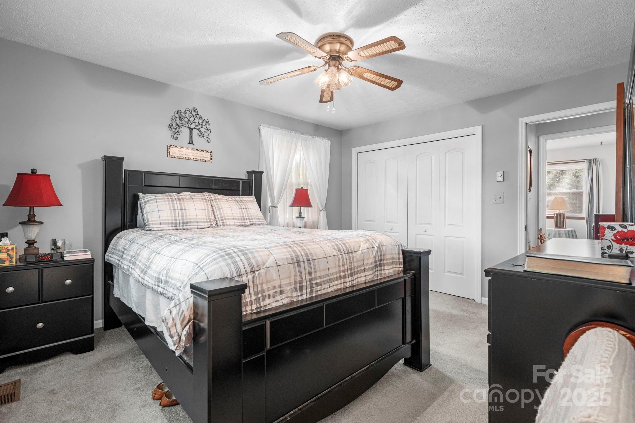3651 Pea Ridge Road Morganton, NC 28655 - Photo 21 of 43 a bed room with a bed and a chandelier