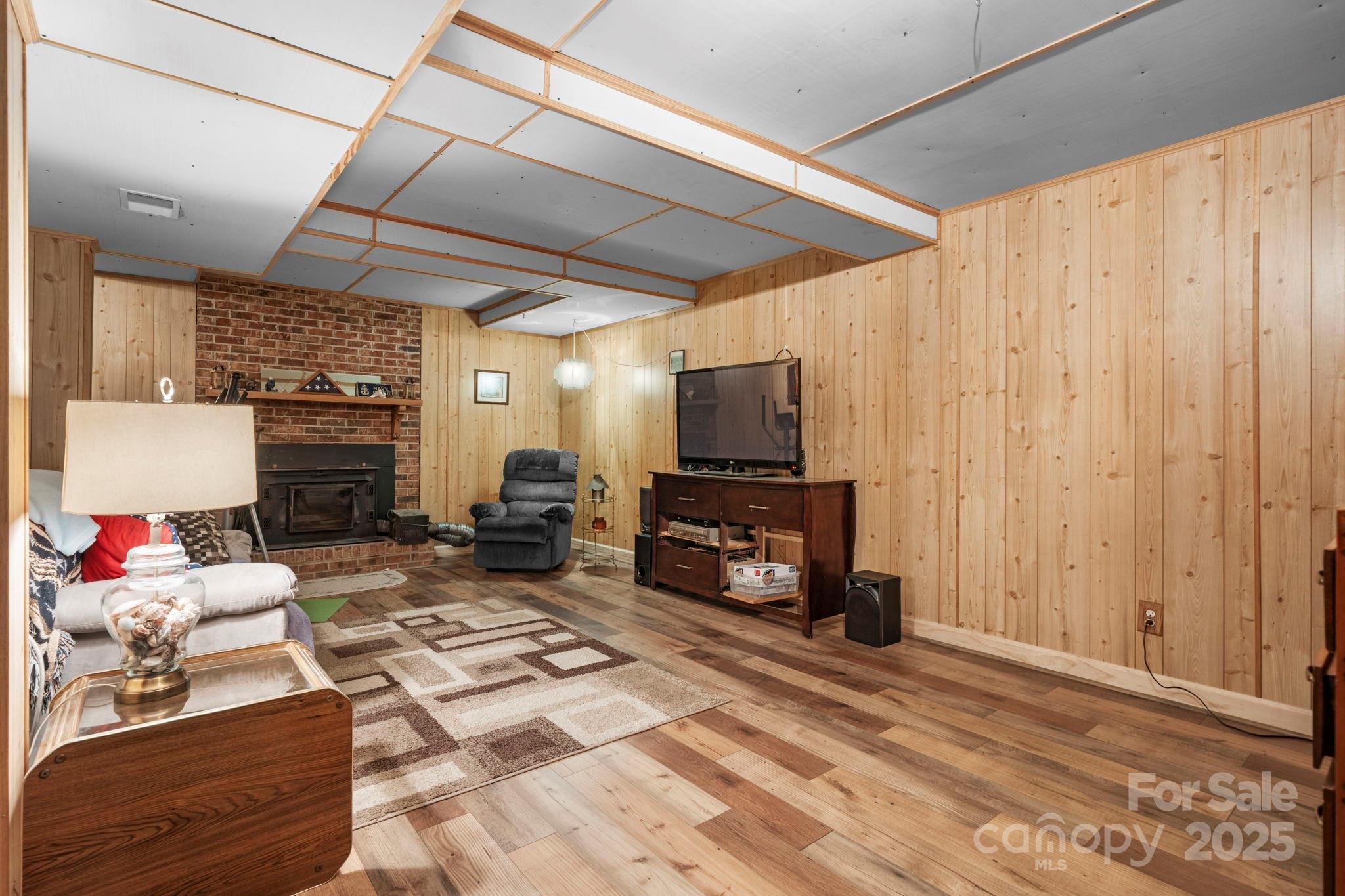 3651 Pea Ridge Road Morganton, NC 28655 - Photo 26 of 43 a living room with furniture a fireplace and a flat screen tv