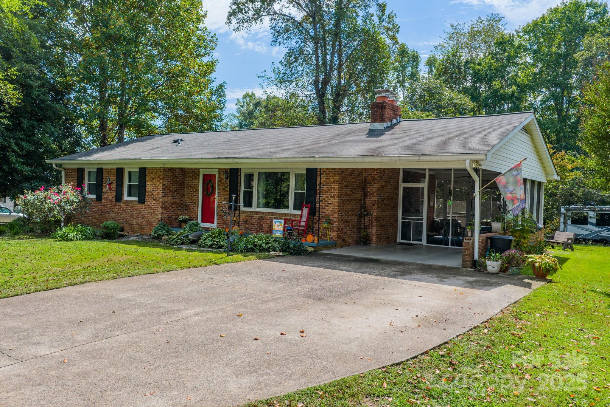 3651 Pea Ridge Road Morganton, NC 28655 - Photo 4 of 43 a view of a house with a yard plants and large tree