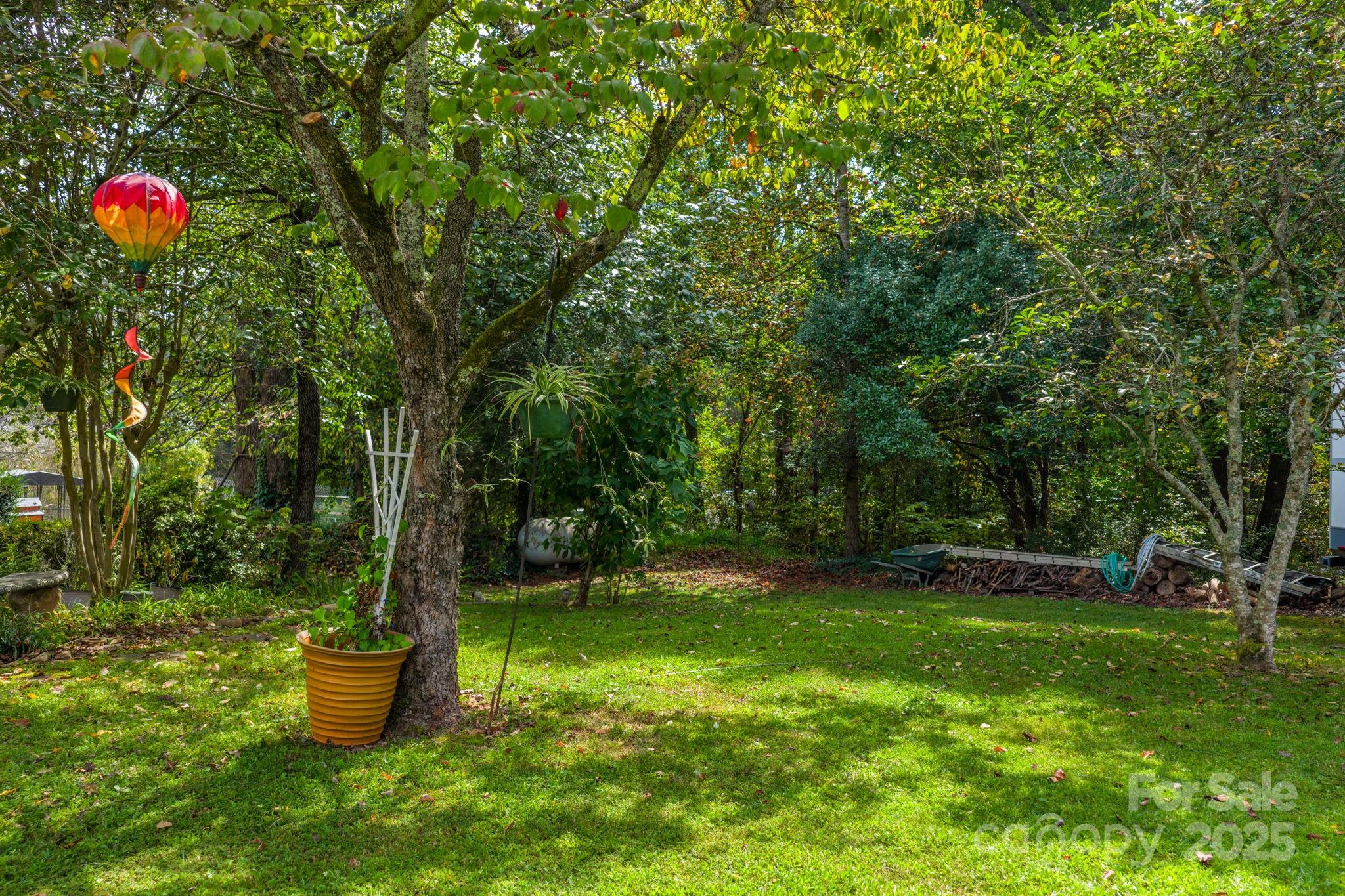 3651 Pea Ridge Road Morganton, NC 28655 - Photo 41 of 43 a backyard of a house with fountain table and chairs