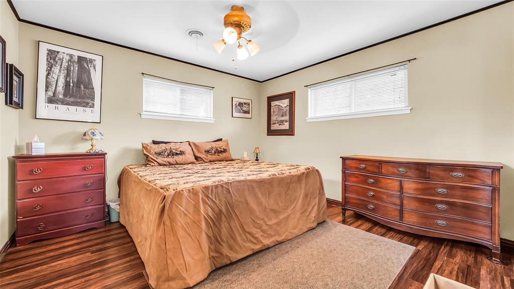 193 Eisenhower Road Denison, TX 75020 - Photo 11 of 30 Bedroom with ornamental molding, dark wood-type flooring, and ceiling fan