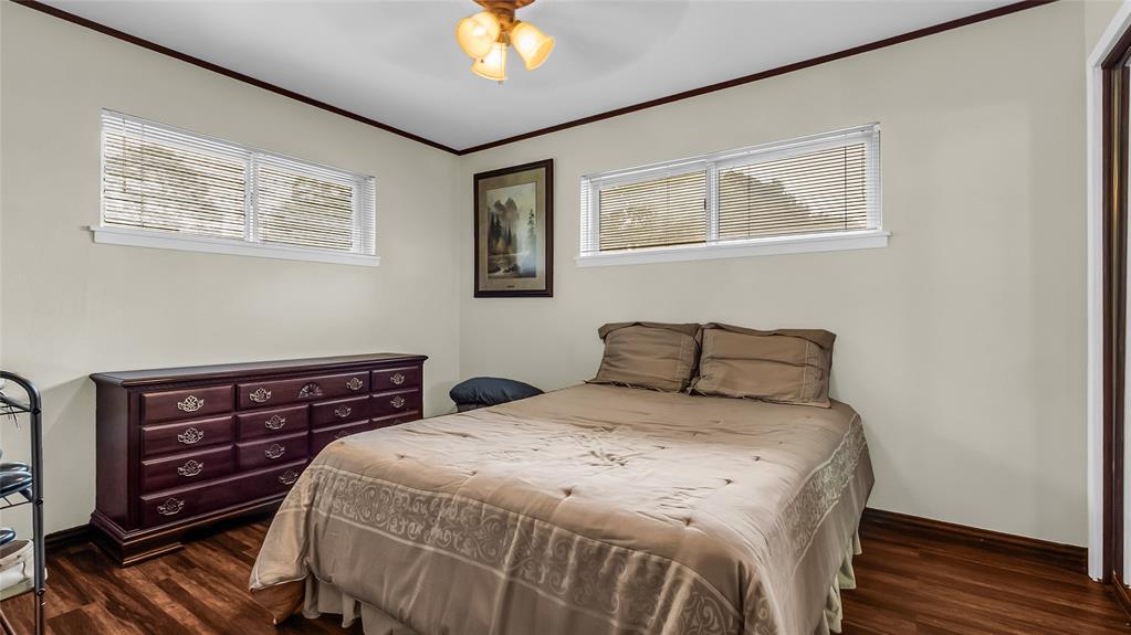 193 Eisenhower Road Denison, TX 75020 - Photo 12 of 30 Bedroom with ornamental molding, dark wood-style flooring, and ceiling fan