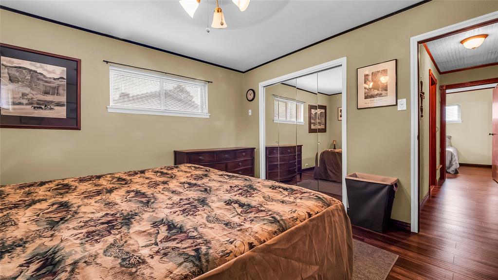 193 Eisenhower Road Denison, TX 75020 - Photo 10 of 30 Bedroom with dark wood finished floors, a closet, and crown molding