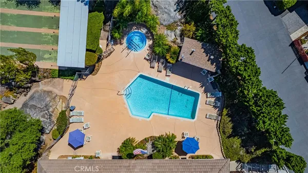 an aerial view of a house with a garden and mountain view