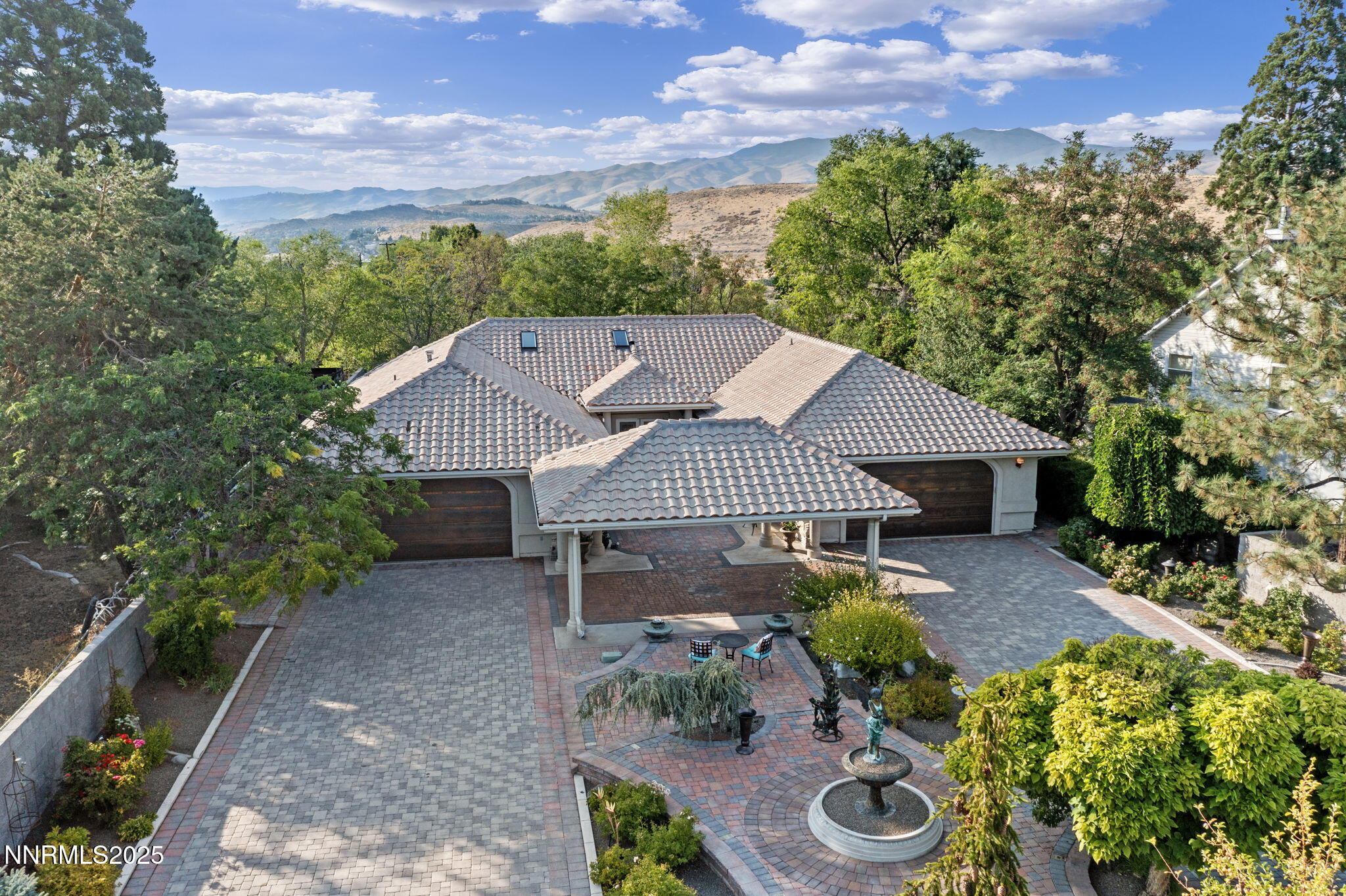 a view of a house with a yard and potted plants