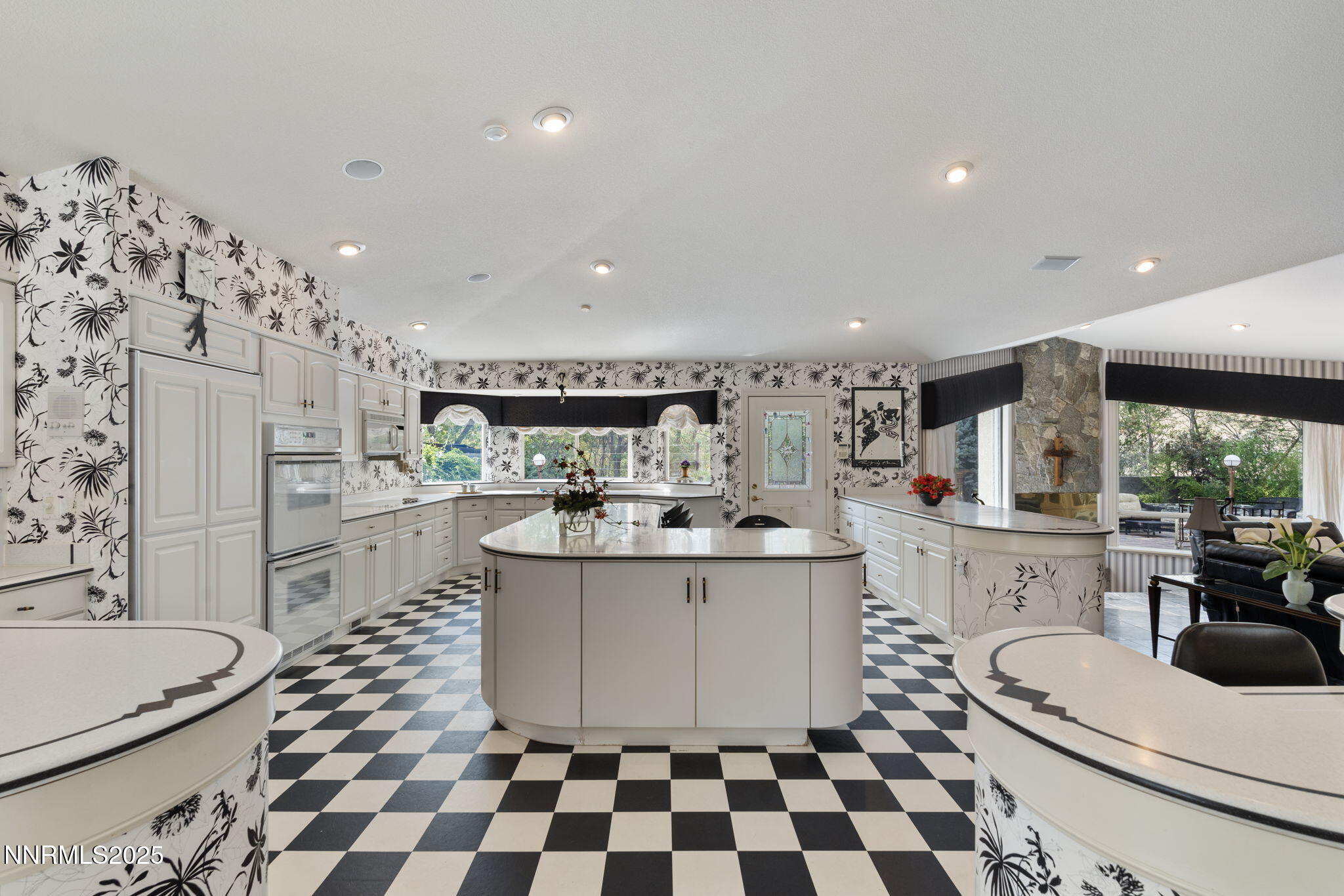 5195 Canyon Drive Reno, NV 89519 - Photo 21 of 69 a kitchen with stainless steel appliances a sink a stove a refrigerator and white cabinets with wooden floor