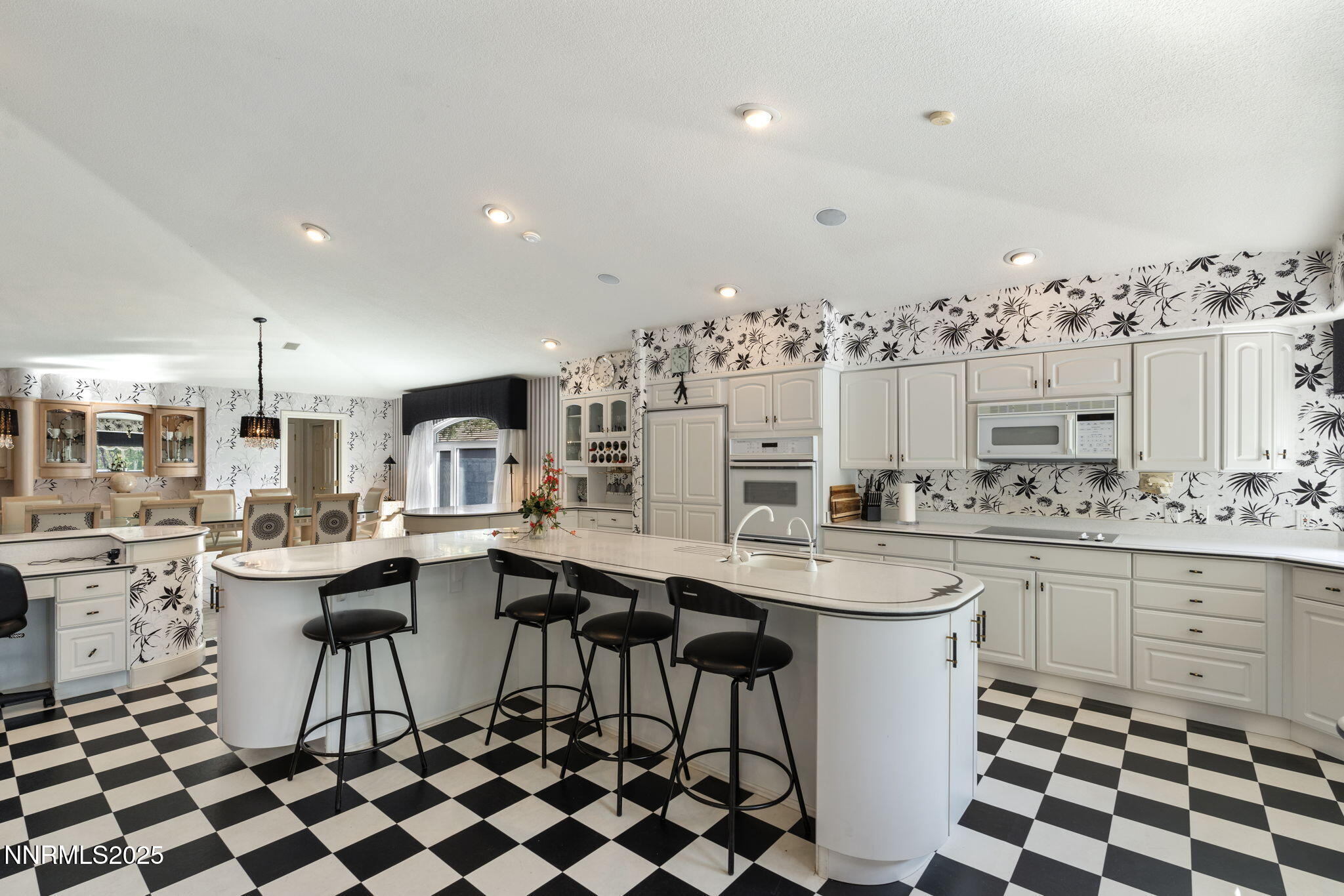 5195 Canyon Drive Reno, NV 89519 - Photo 23 of 69 a kitchen with stainless steel appliances a dining table and chairs