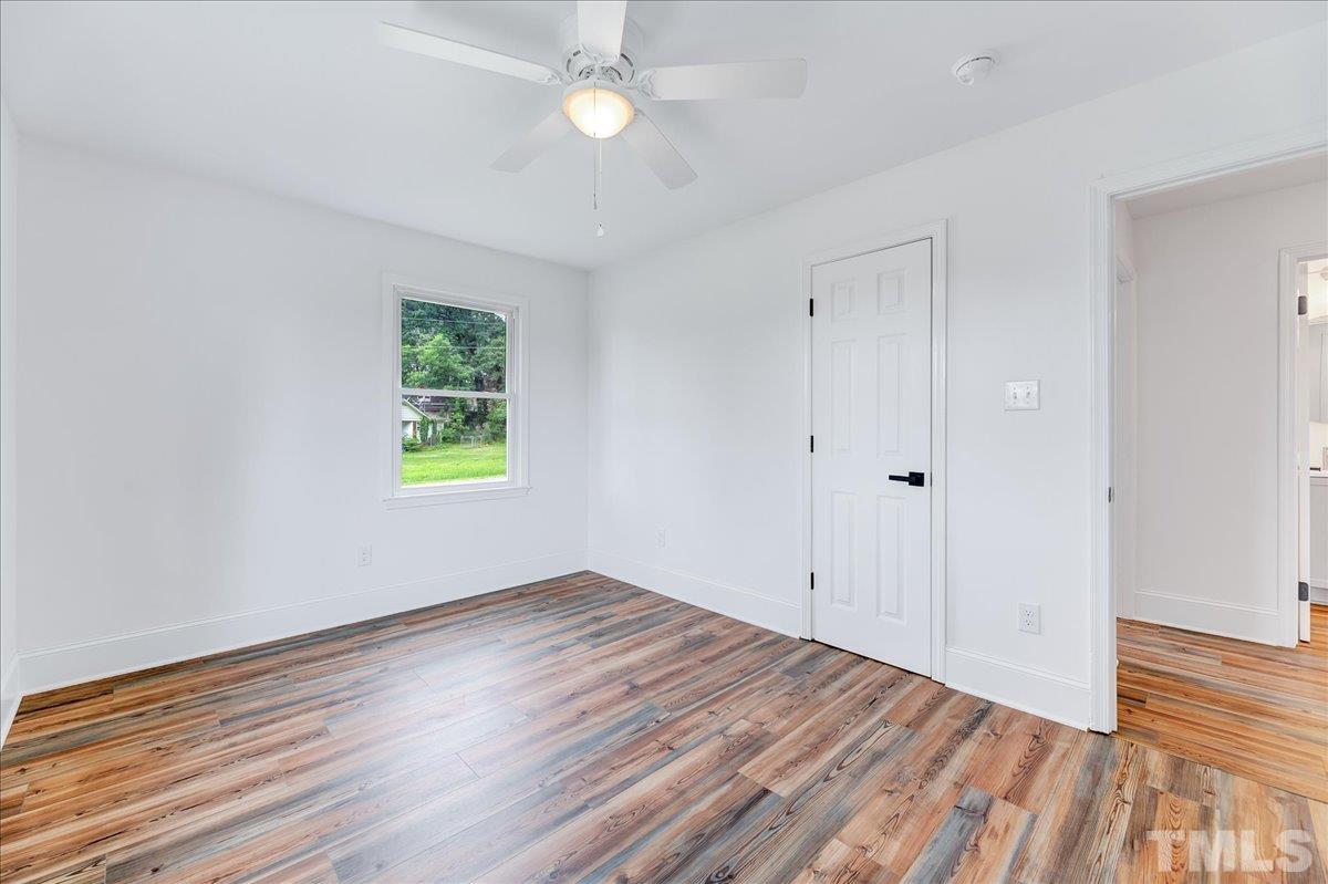 3708 Oakvale Street Raleigh, NC 27603 - Photo 20 of 39 a view of an empty room with wooden floor and a window