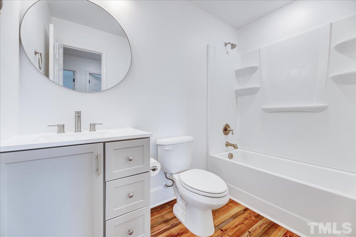 3708 Oakvale Street Raleigh, NC 27603 - Photo 21 of 39 a bathroom with a sink toilet and shower