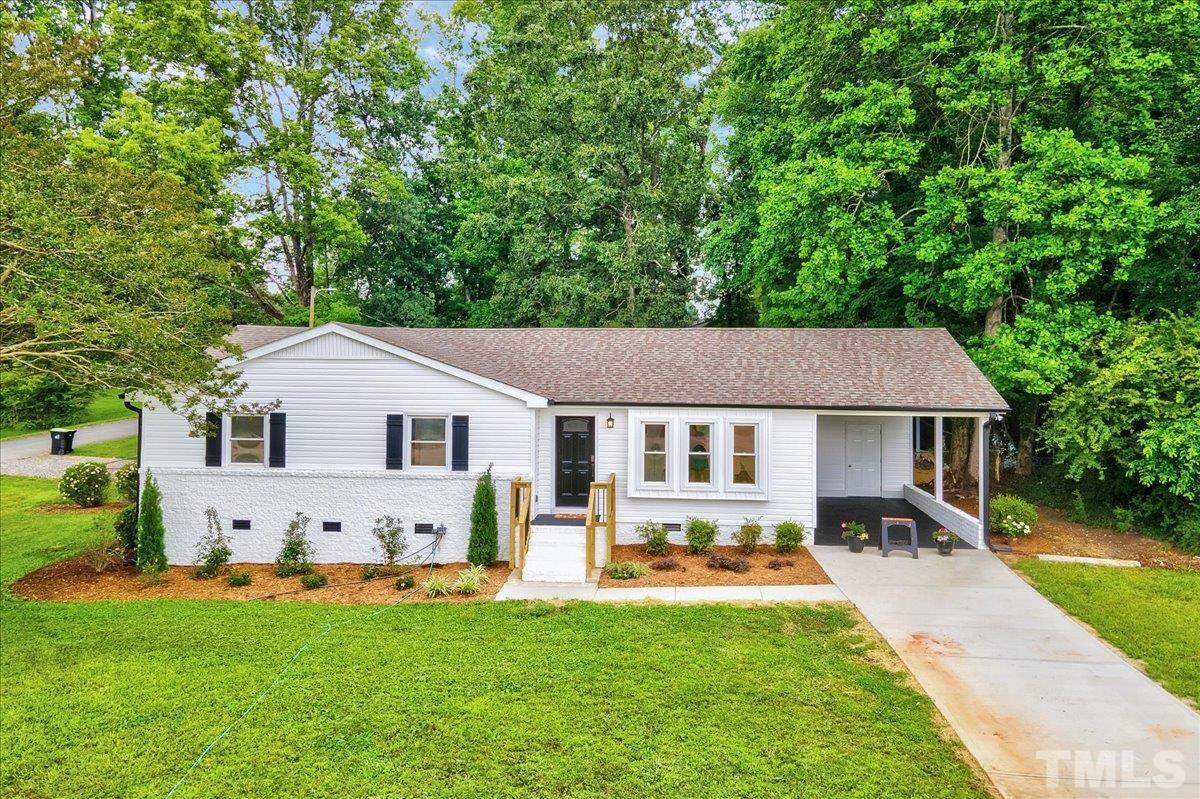 3708 Oakvale Street Raleigh, NC 27603 - Photo 4 of 39 a view of a house with a yard and sitting area