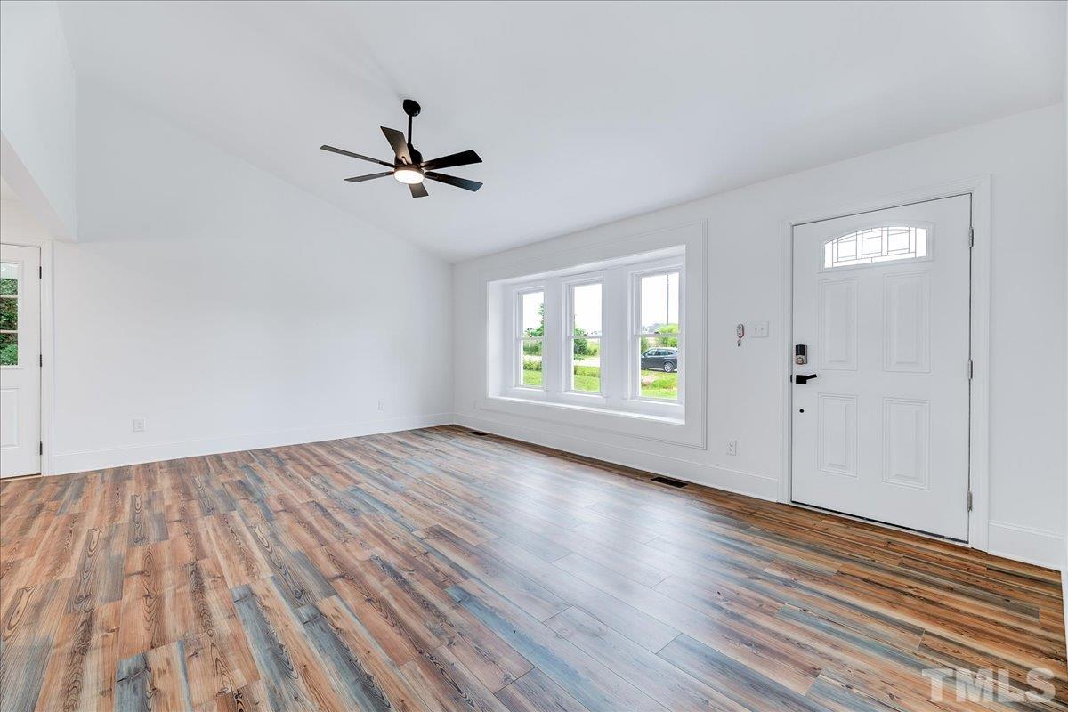 3708 Oakvale Street Raleigh, NC 27603 - Photo 7 of 39 wooden floor in an empty room with a window