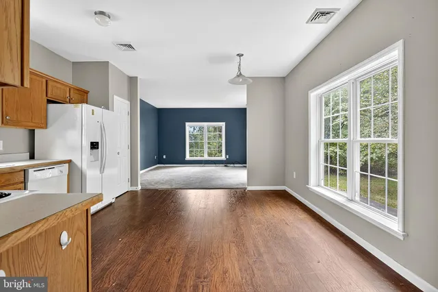 a view of a kitchen cabinets and wooden floor