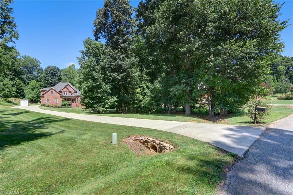 605 Stafford Pointe Court Oak Ridge, NC 27310 - Photo 2 of 30 Beautiful lot with long concrete drive to this secluded home.