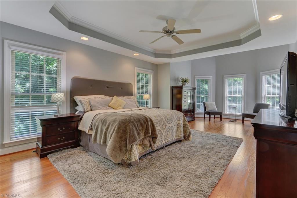 605 Stafford Pointe Court Oak Ridge, NC 27310 - Photo 15 of 30 Your private and luxurious owner's suite boasts lots of windows, a tray ceiling, and a sitting area. Note that there are no rooms above your bedroom, so the kids or guests can make all of the noise they want and not disturb you