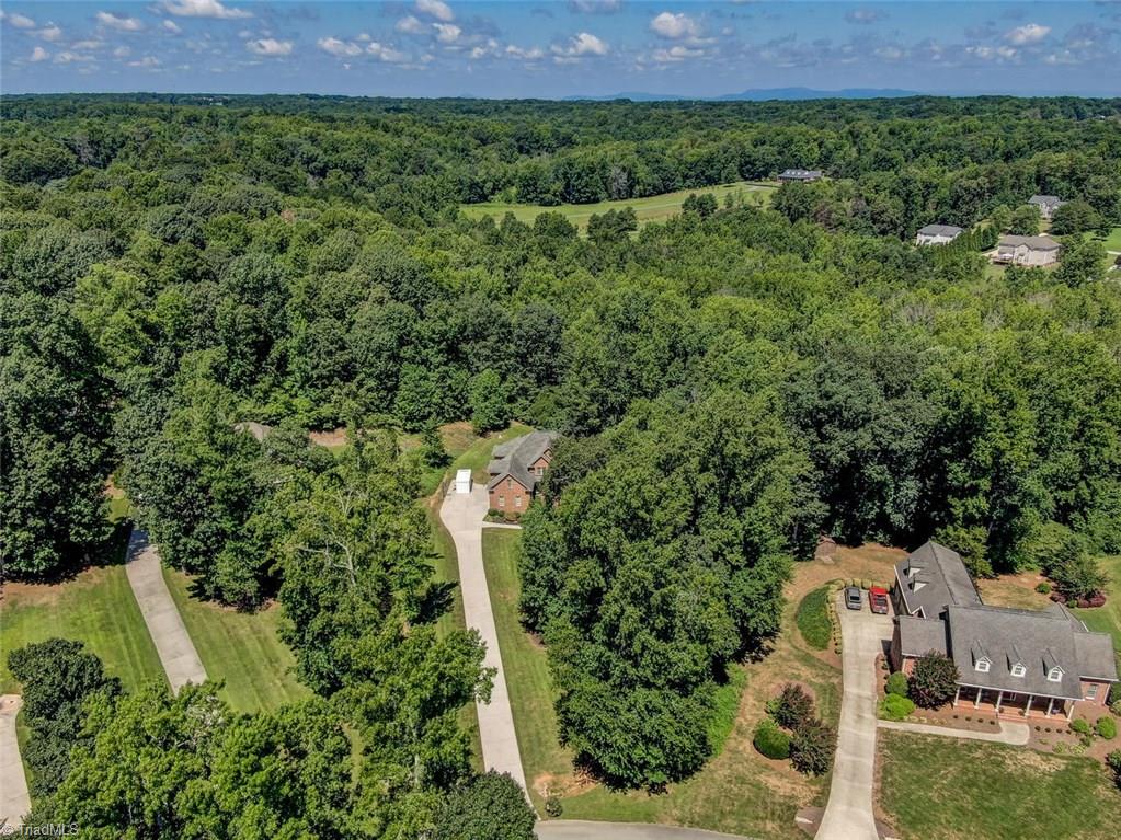 605 Stafford Pointe Court Oak Ridge, NC 27310 - Photo 3 of 30 As you can tell, the all brick home sits perfectly back on the large lot with unbuildable land behind for buffer