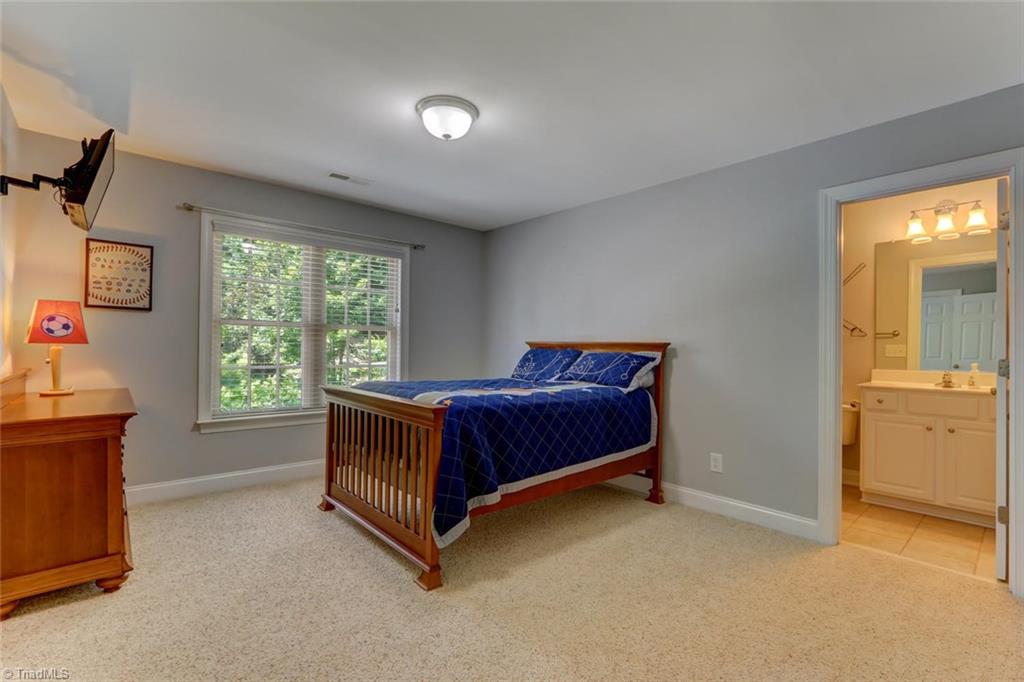 605 Stafford Pointe Court Oak Ridge, NC 27310 - Photo 21 of 30 Another upstairs bedroom with attached tiled bathroom