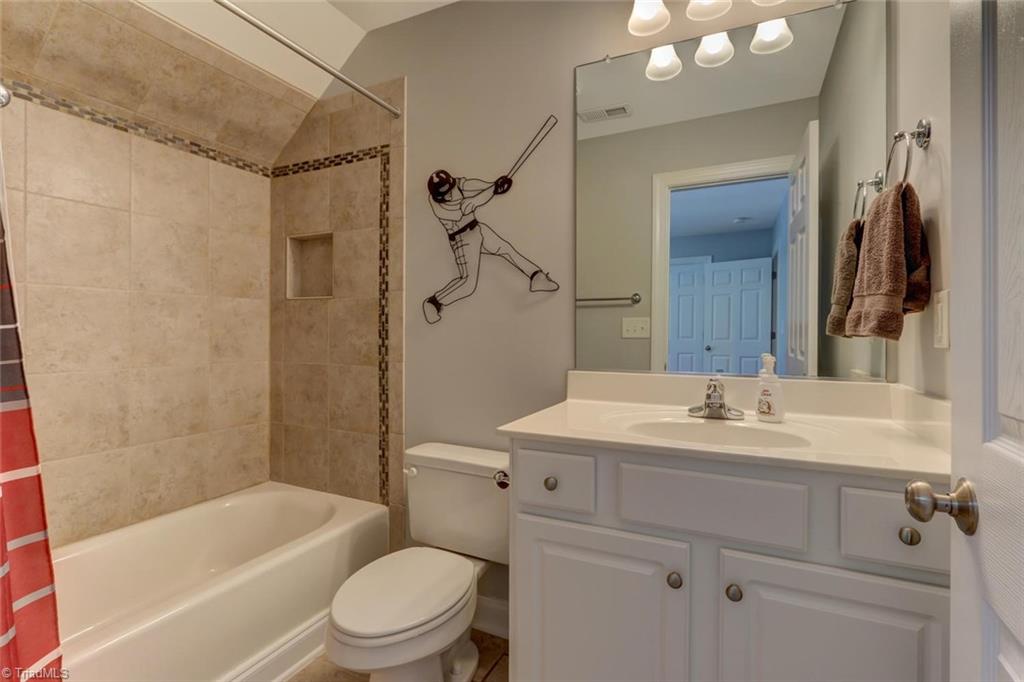 605 Stafford Pointe Court Oak Ridge, NC 27310 - Photo 22 of 30 Notice the gorgeous tile work in the tub/shower, no plastic insert shower/tub in this home