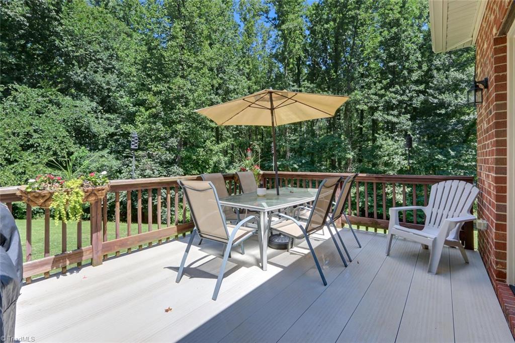 605 Stafford Pointe Court Oak Ridge, NC 27310 - Photo 26 of 30 An expansive back deck with trex floor decking overlooks the spacious and private backyard.