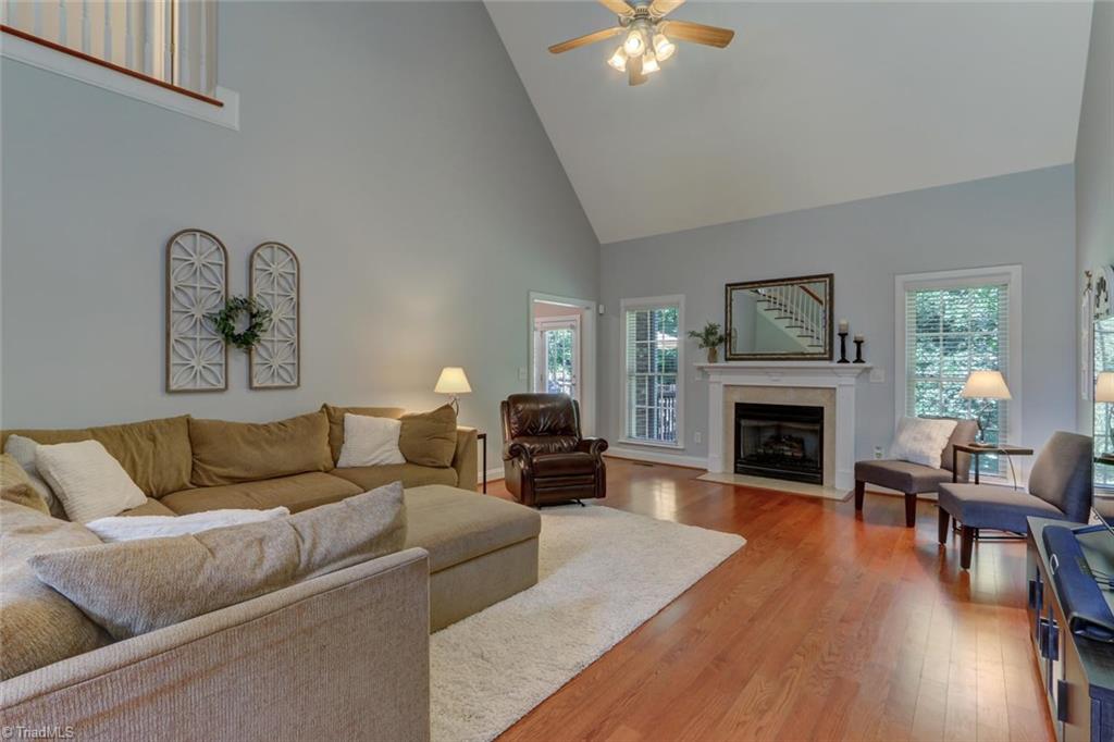 605 Stafford Pointe Court Oak Ridge, NC 27310 - Photo 6 of 30 A vaulted great room with fireplace offers you lots of ways to organize your furniture to make this home yours