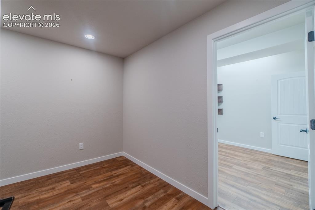 1061 Native Dancer Terrace Colorado Springs, CO 80921 - Photo 45 of 50 Interior room featuring wood-finish flooring, recessed lighting, and a white baseboard trim