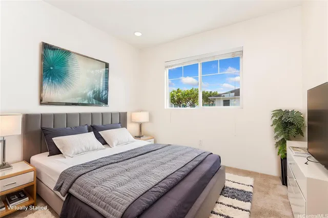 a bedroom with a bed and a potted plant