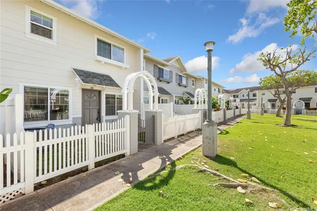 a view of a house with a yard and porch