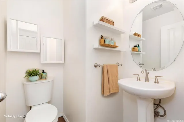 a bathroom with a toilet sink and mirror