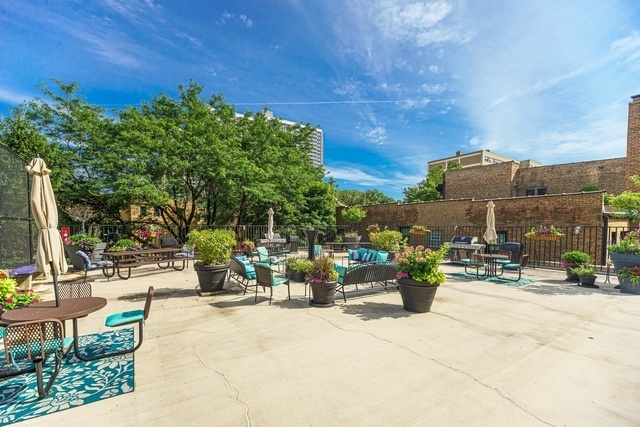 720 West Gordon Terrace, Unit 5B Chicago, IL 60613 - Photo 15 of 20 a view of a patio with a table and chairs and potted plants