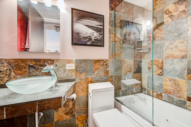 720 West Gordon Terrace, Unit 5B Chicago, IL 60613 - Photo 8 of 20 a bathroom with a sink toilet and shower