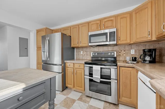a kitchen with stainless steel appliances granite countertop a refrigerator stove and microwave