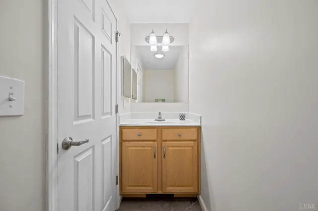 a bathroom with a sink a mirror and a light fixture