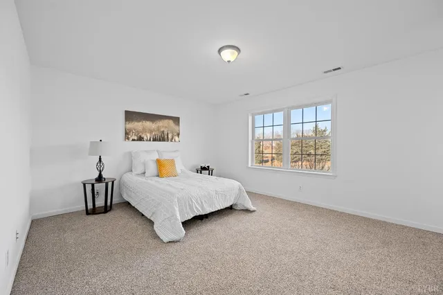 a bed room with a bed and a large window