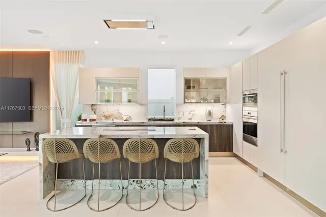 a kitchen with stainless steel appliances granite countertop a sink and a refrigerator