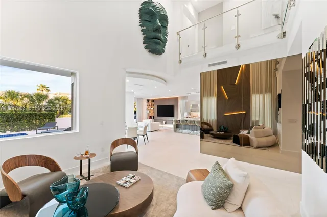 a living room with furniture fireplace and a large window