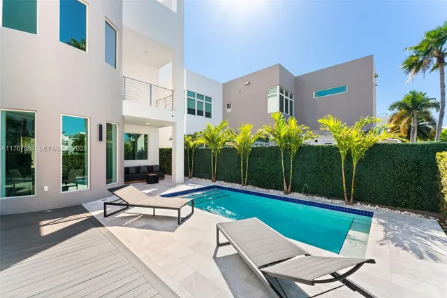 a view of a house with backyard sitting area and garden