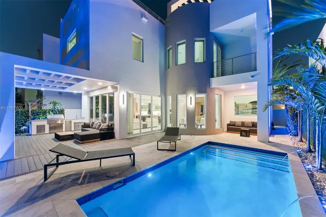 a living room with patio furniture and a large window