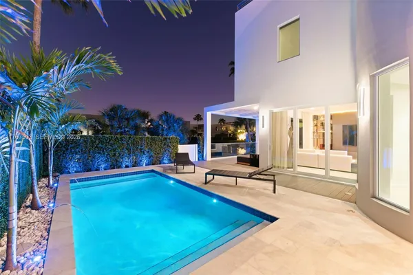 a swimming pool with outdoor seating and yard