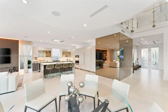 a living room with lots of furniture and kitchen view