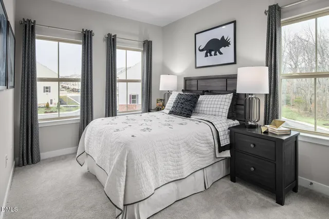 a bed sitting in a bedroom next to a window