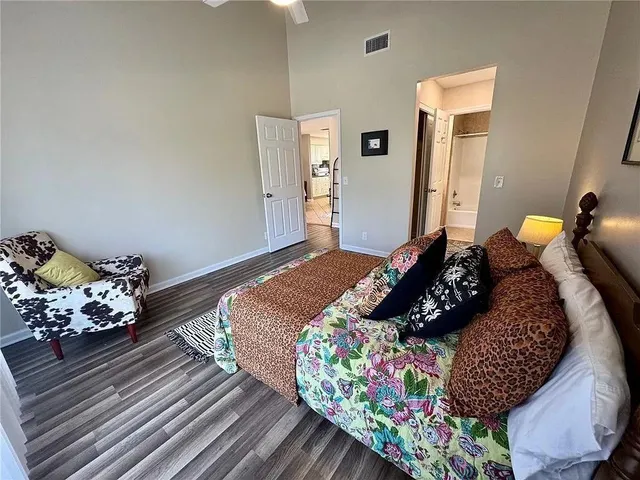a bedroom with bed and wooden floor