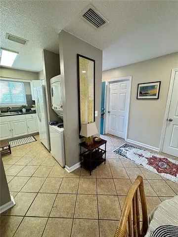 a bedroom with a bed and a large mirror on the dresser