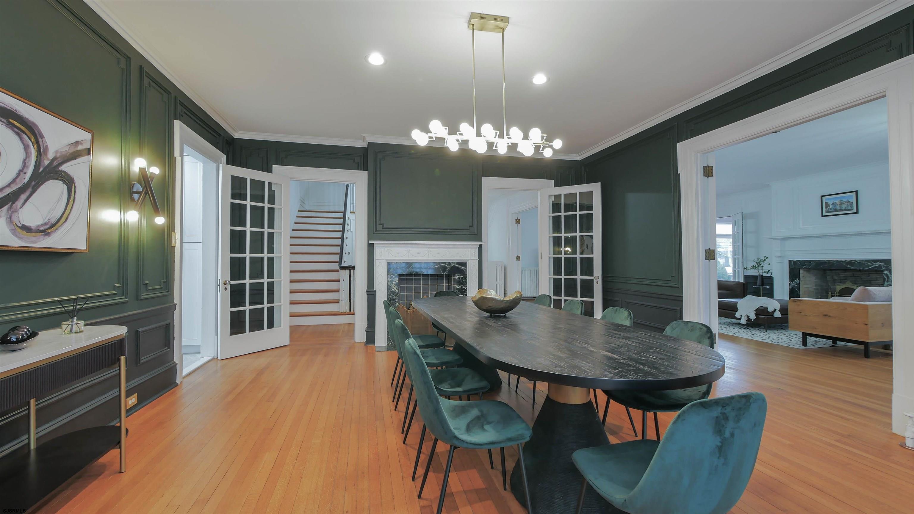 4700 Atlantic Avenue Atlantic City, NJ 08401 - Photo 15 of 74 a view of a dining room with furniture a chandelier and wooden floor