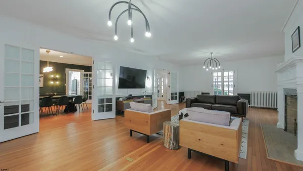 a living room with furniture and a chandelier