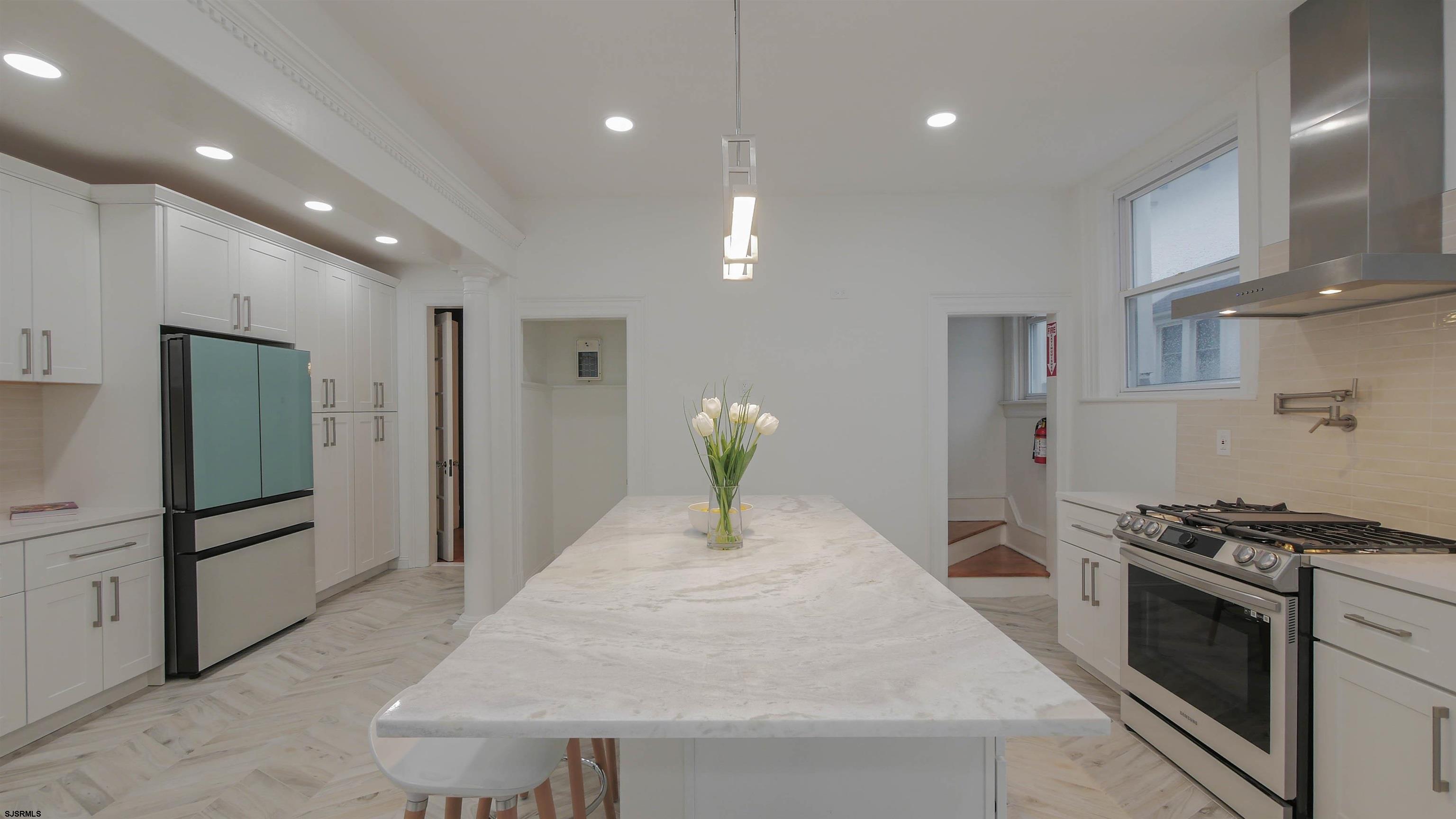 4700 Atlantic Avenue Atlantic City, NJ 08401 - Photo 21 of 74 a kitchen with stainless steel appliances kitchen island granite countertop a stove a refrigerator and a cabinets