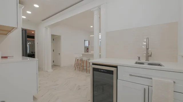 a living room with furniture a fireplace and a large window