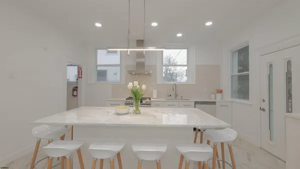 a dining room with furniture and wooden floor