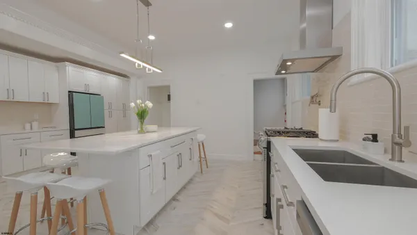 a living room with furniture a chandelier and a window